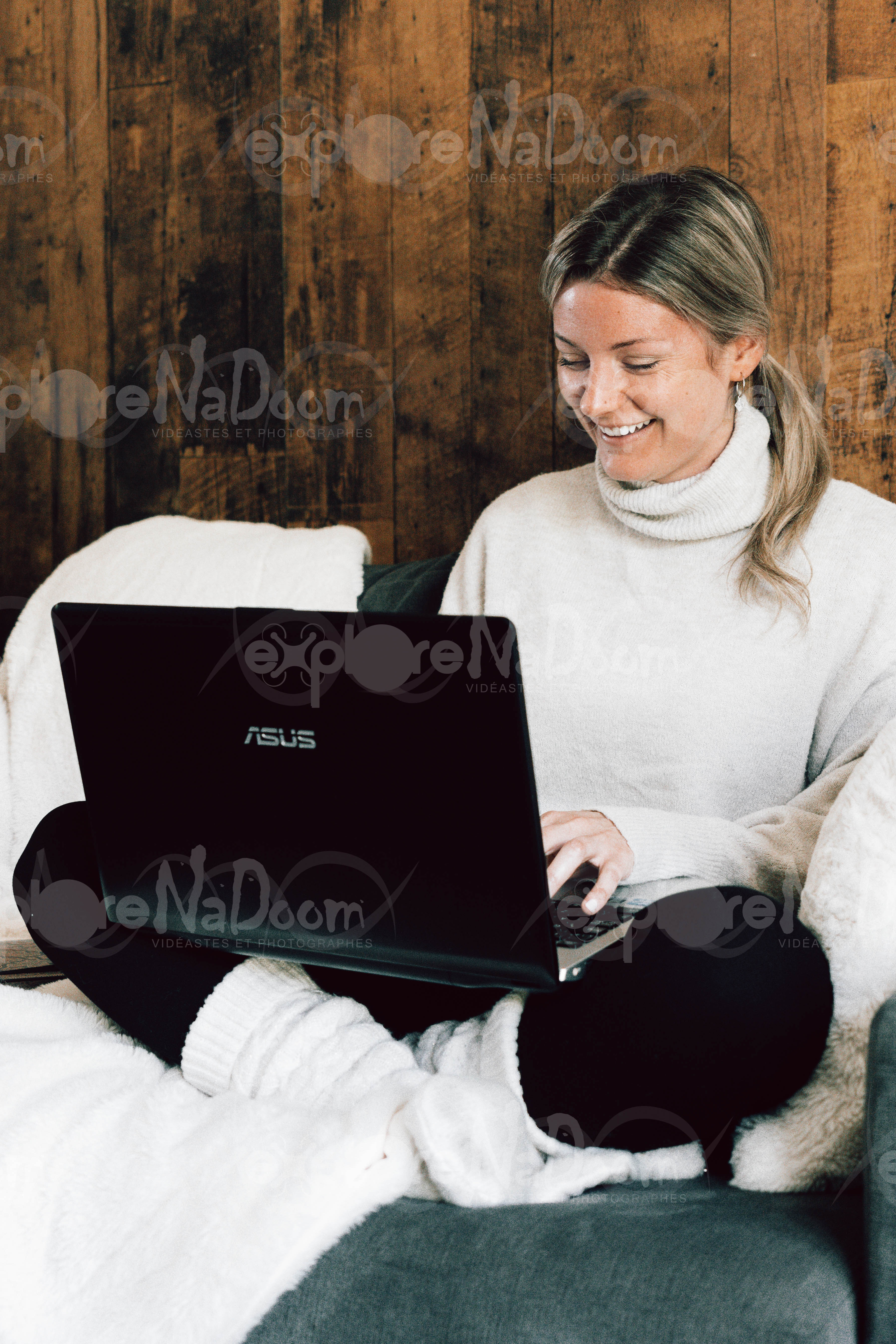 Femme assise sur un divan qui travail sur un portable – 6